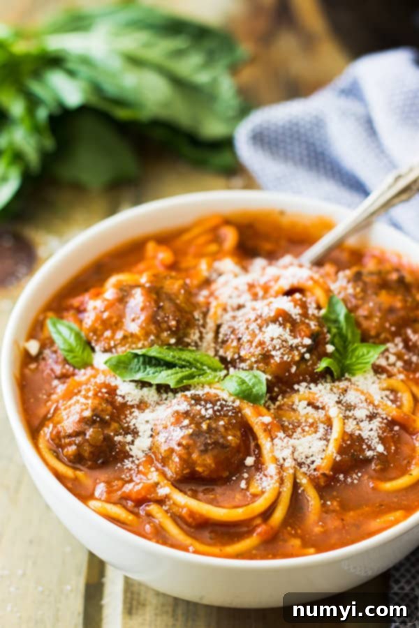 Preparing the Slow Cooker Spaghetti Meatball Soup with browned meatballs and fresh vegetables