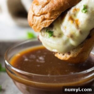 An easy recipe for Slow Cooker French Dip Sandwiches! These are filled with tender and flavorful beef, melty cheese and a beefy au jus for dipping! | www.countrysidecravings.com