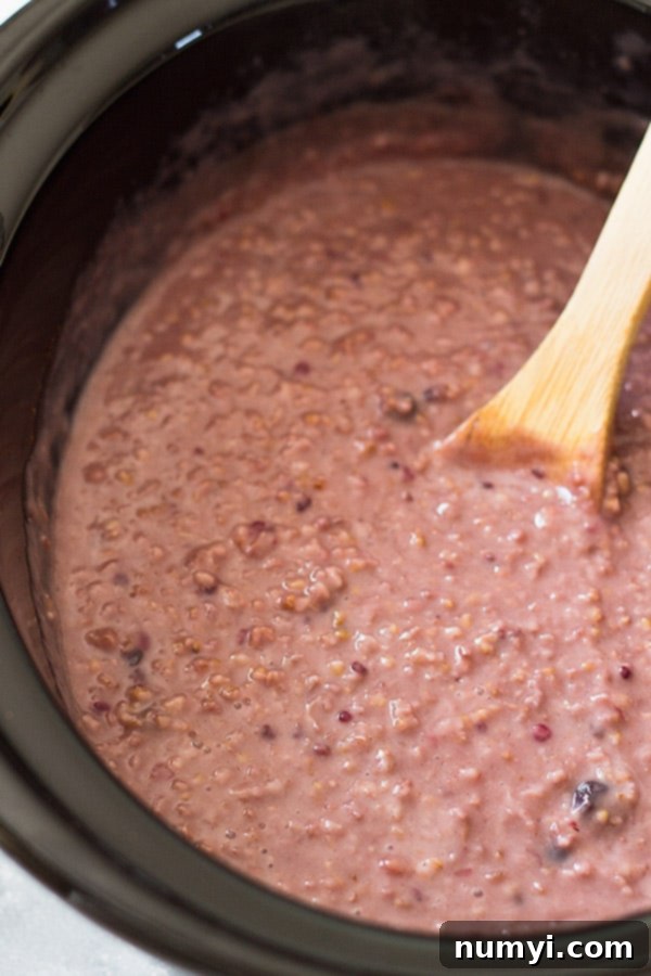 Slow Cooker Berry Oatmeal is a wonderfully hearty breakfast using steel cut oats, frozen mixed berries and your trusty crockpot! Enjoy healthy, easy overnight oats.