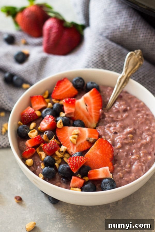 A close-up of Slow Cooker Berry Oatmeal, showcasing the creamy texture and colorful berries. Perfect for a hearty morning meal.