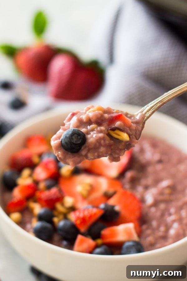 Slow Cooker Berry Oatmeal topped with fresh fruit and nuts, highlighting healthy and customizable breakfast options.