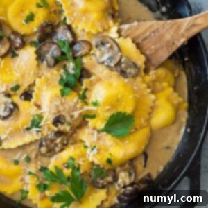 This Cheese Ravioli in Creamy Mushroom Sauce is made easy using store bought ravioli and made extra decadent with a simple garlic mushroom cream sauce! | www.countrysidecravings.com