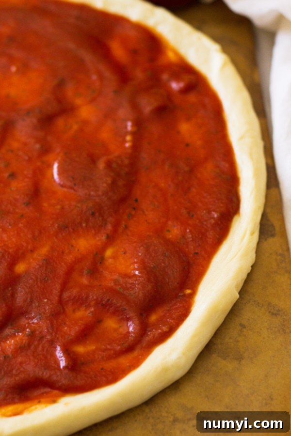 A glass jar filled with freshly made homemade pizza sauce, demonstrating proper storage and readiness for future use.