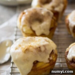 A top-down view of cinnamon roll muffins in a wooden bowl, ready for serving.