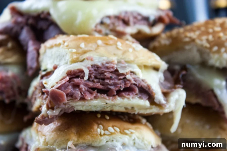 Smoky Roast Beef Sliders with Zingy Horseradish 3 Roast Beef Sliders with Horseradish Sauce stacked on a platter.