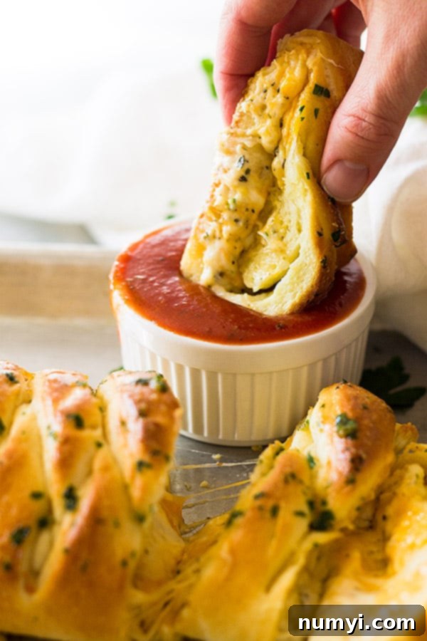 This Three Cheese Braid is filled with gooey melted cheese and is great dipped in homemade pizza sauce! 