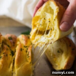 This Three Cheese Braid is filled with melted mozzarella, cheddar and Parmesan cheese. Then baked in a golden crust and brushed with butter and garlic!