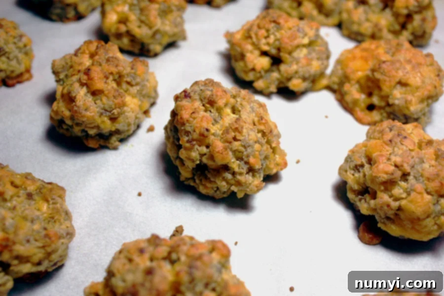 Golden-brown Sausage Balls arranged on a sheet pan, ready to serve.