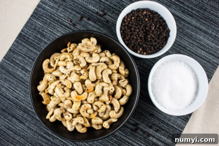 Homemade Salt and Pepper Roasted Cashews served in a black bowl, perfect for snacking.