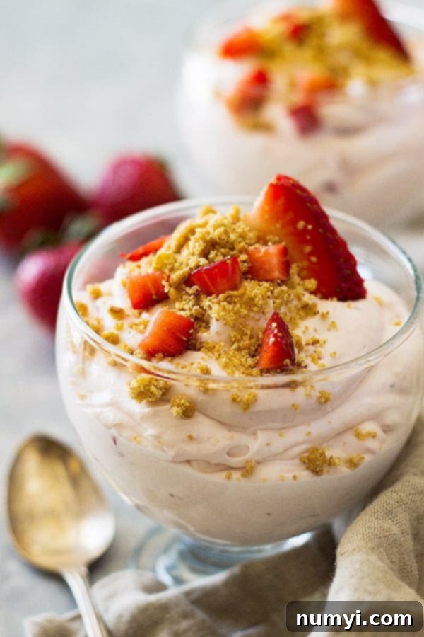 Front view of strawberry cheesecake fluff with strawberries.