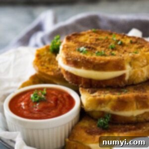 Gourmet Italian Grilled Cheese 5 Grilled cheese sandwiches next to small while bowl of pizza sauce.