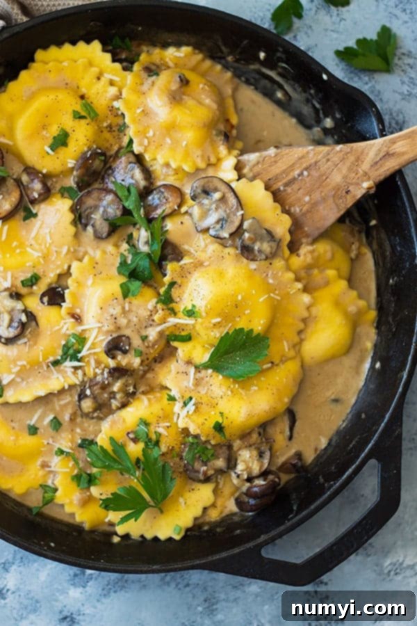 This Cheese Ravioli in Creamy Mushroom Sauce is made easy using store bought ravioli and made extra decadent with a simple garlic mushroom cream sauce! | www.countrysidecravings.com