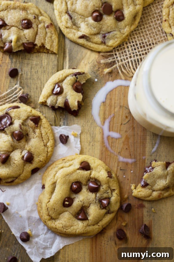 Top view of no chill soft chocolate chip cookies on wooden table with milk 