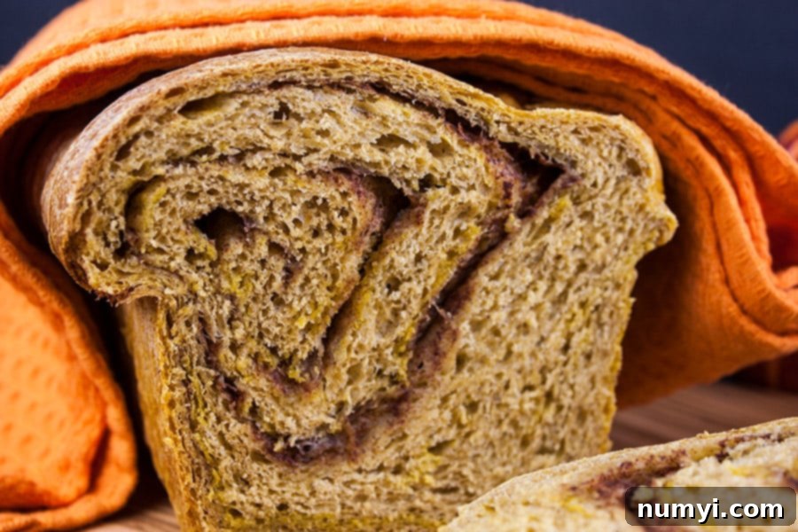 Pumpkin Cinnamon Swirl Bread cut so you can see the cinnamon swirl.
