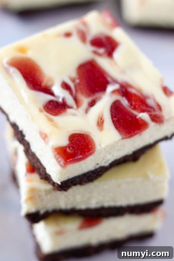 Delicious Strawberry Cheesecake Bars with a graham cracker crust and fruity topping.