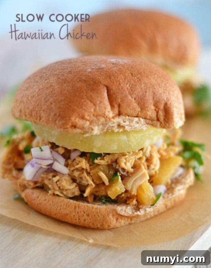 Delicious Slow Cooker Hawaiian Chicken served with rice and pineapple chunks.
