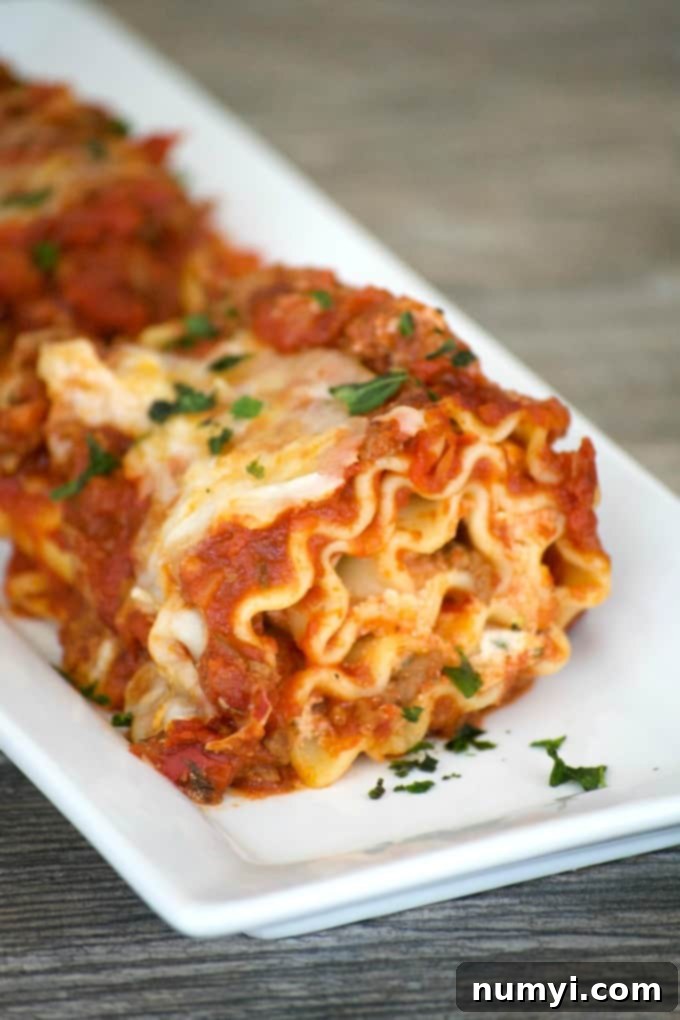 Delicious Lasagna Rolls with Meat Sauce, baked golden brown in a casserole dish.