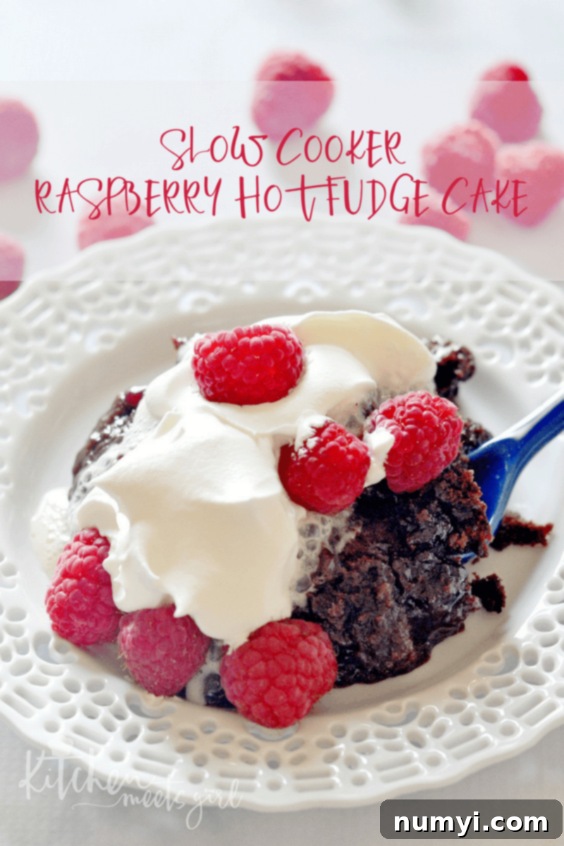 Slow Cooker Raspberry Hot Fudge Cake, a rich and gooey chocolate dessert with raspberries, made effortlessly in a slow cooker.