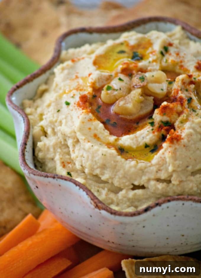 Creamy Roasted Garlic Hummus, a healthy and flavorful dip perfect for snacking or as a spread.