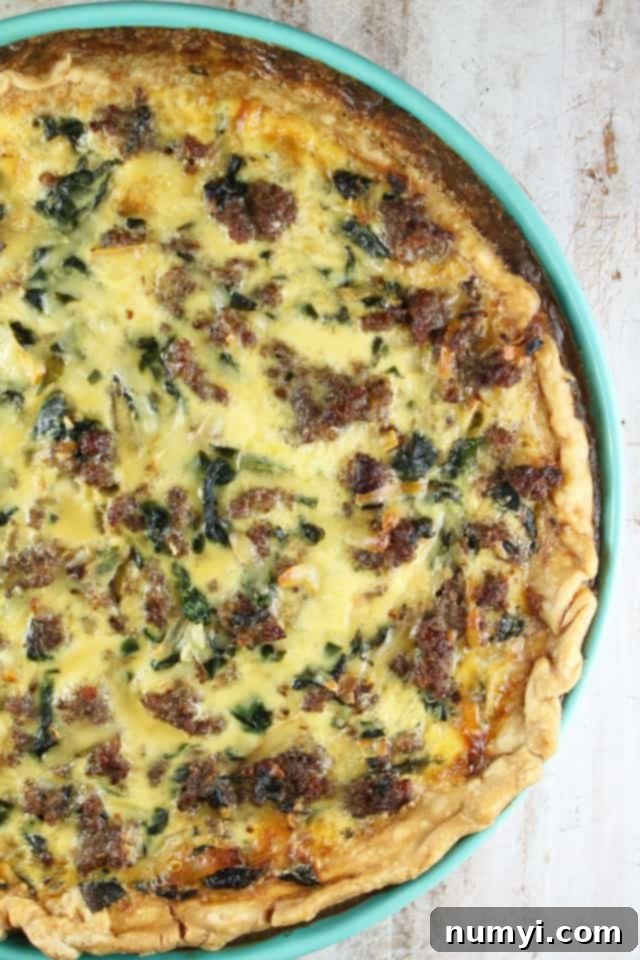 Sausage Spinach Quiche, a delicious and savory breakfast or dinner option filled with fresh spinach and crumbled sausage.