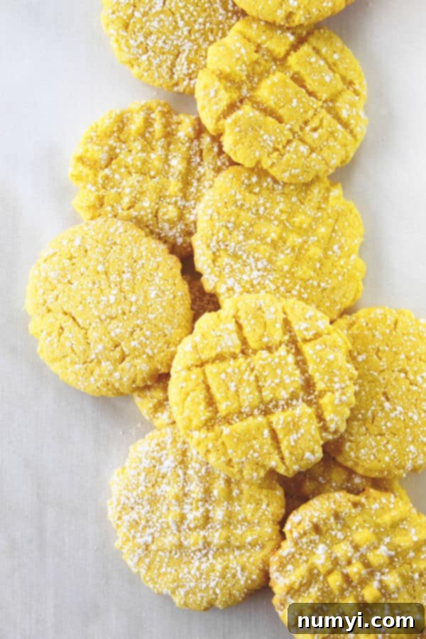 Lemon cake mix cookies with powdered sugar sprinkled on top, showcasing a soft, chewy texture