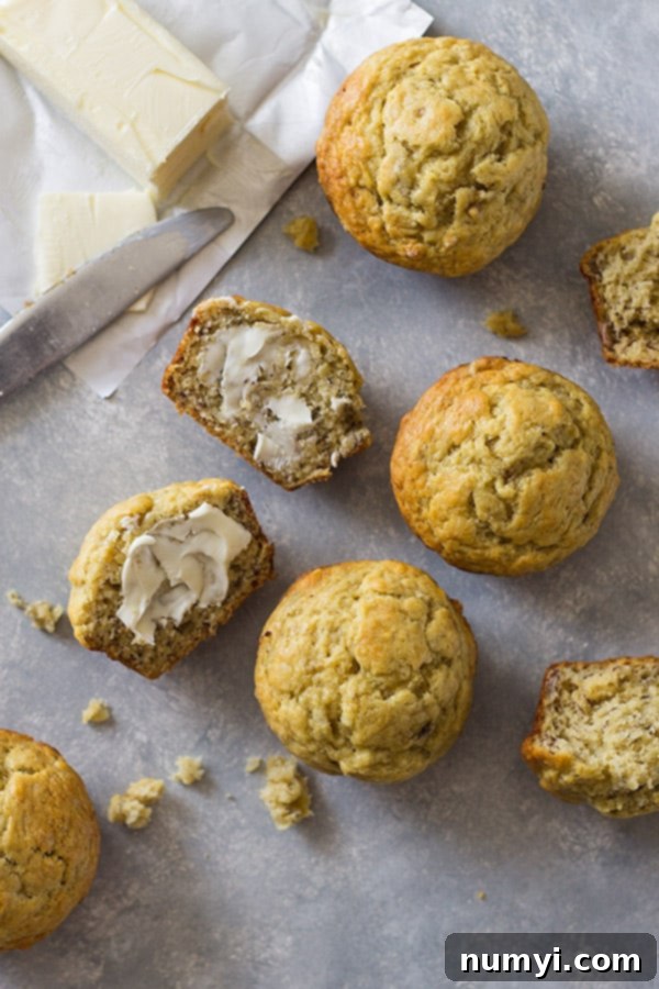 A close-up shot of the perfectly golden-brown tops of freshly baked banana muffins.
