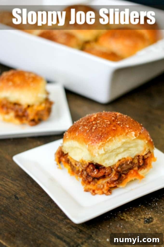 A platter of Sloppy Joe Sliders, with juicy meat filling spilling out of toasted buns, ready for serving.