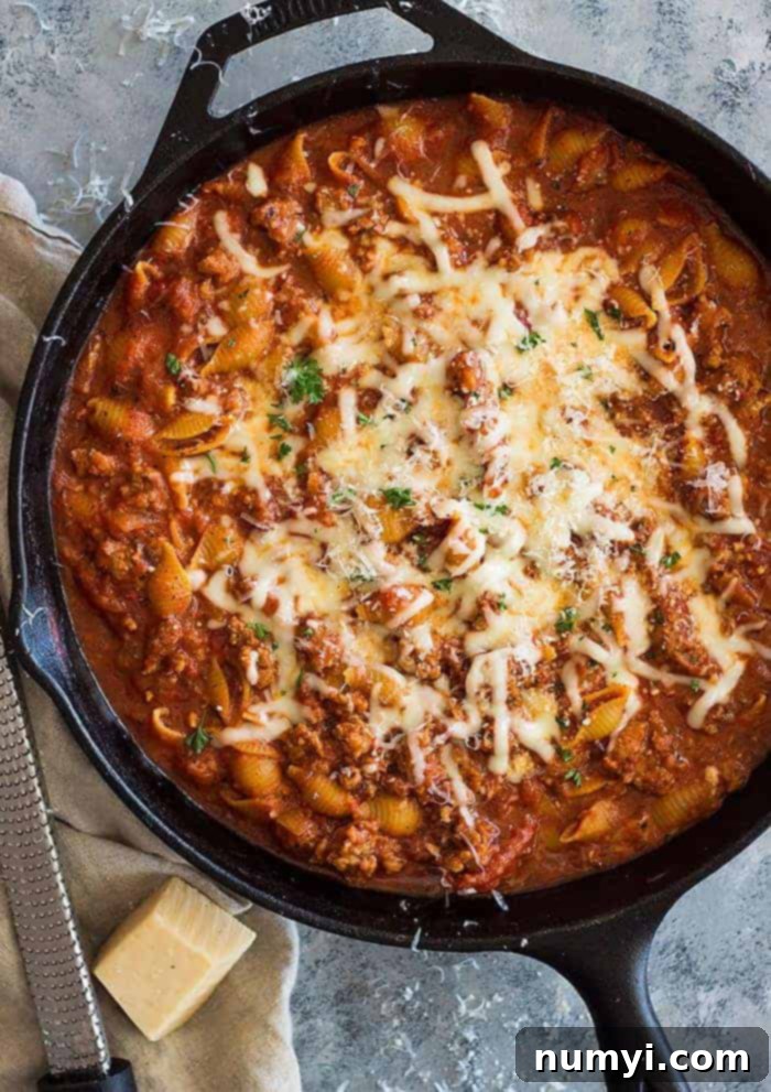 Top shot of One-Pot Italian Sausage Pasta served in a black skillet.