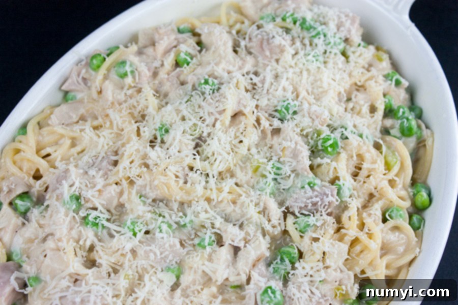 Unbaked turkey tetrazzini in a white casserole dish.