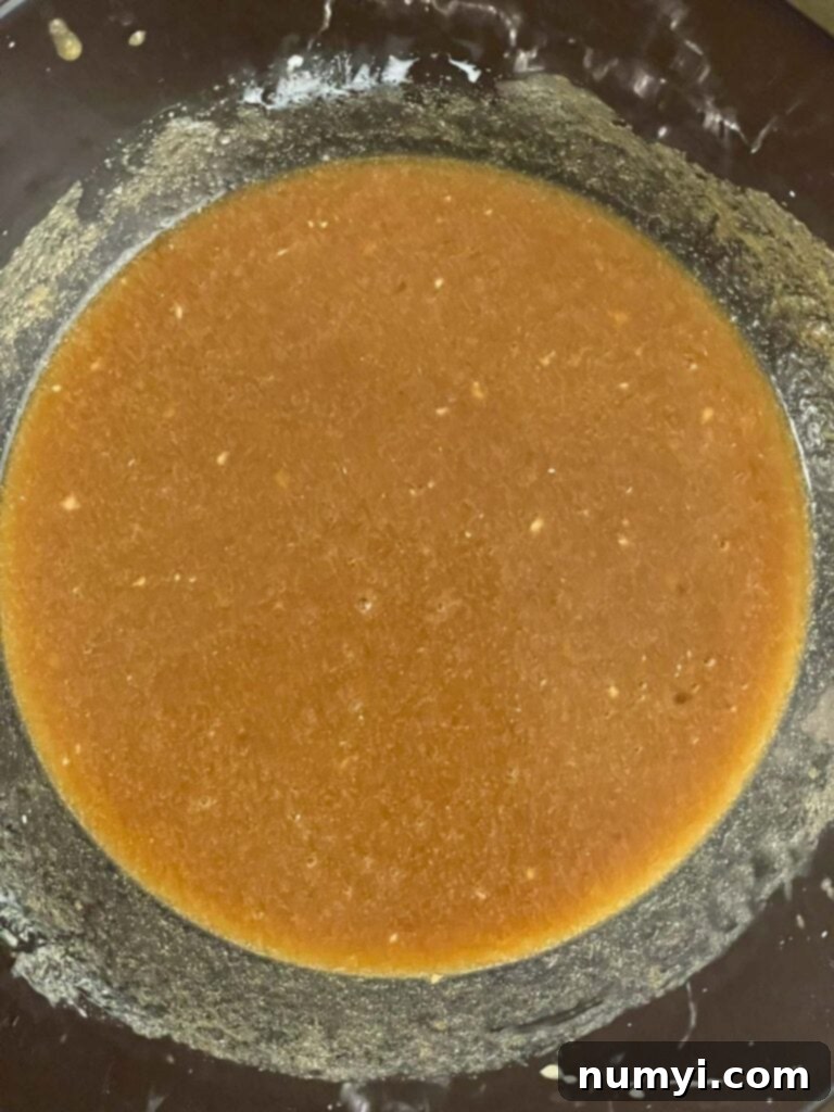 Spiced Apple Cider Baked Doughnuts 4 Wet ingredients and sugar for baked apple cider donuts combined in a glass mixing bowl.