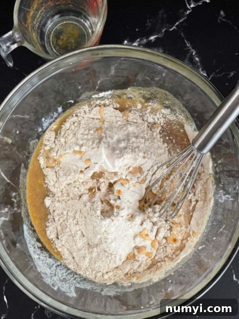 Spiced Apple Cider Baked Doughnuts 5 Dry ingredients added to the wet ingredients for baked apple cider donuts.