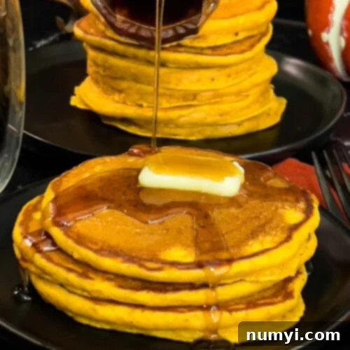 A stacked image of fluffy pumpkin pancakes with butter and maple syrup on a dark plate, showcasing golden edges and a warm inviting look, a perfect fall breakfast.