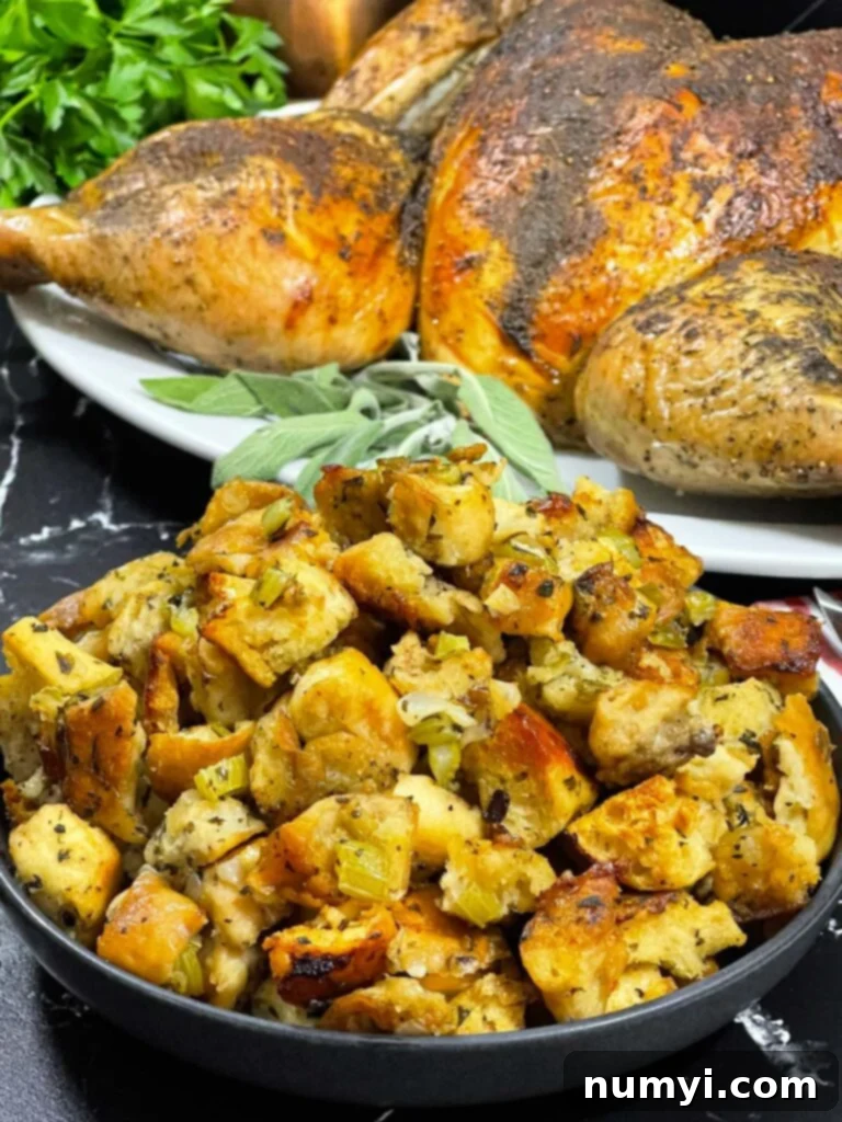 Beautifully roasted spatchcock turkey with herb stuffing on a baking sheet, ready for the holiday table.